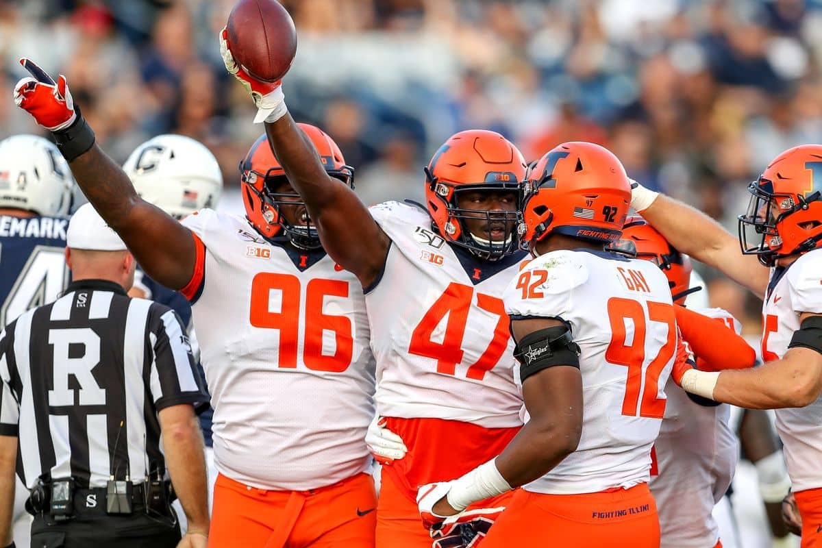Illinois Fighting Illini football players raising arms, signaling a first down