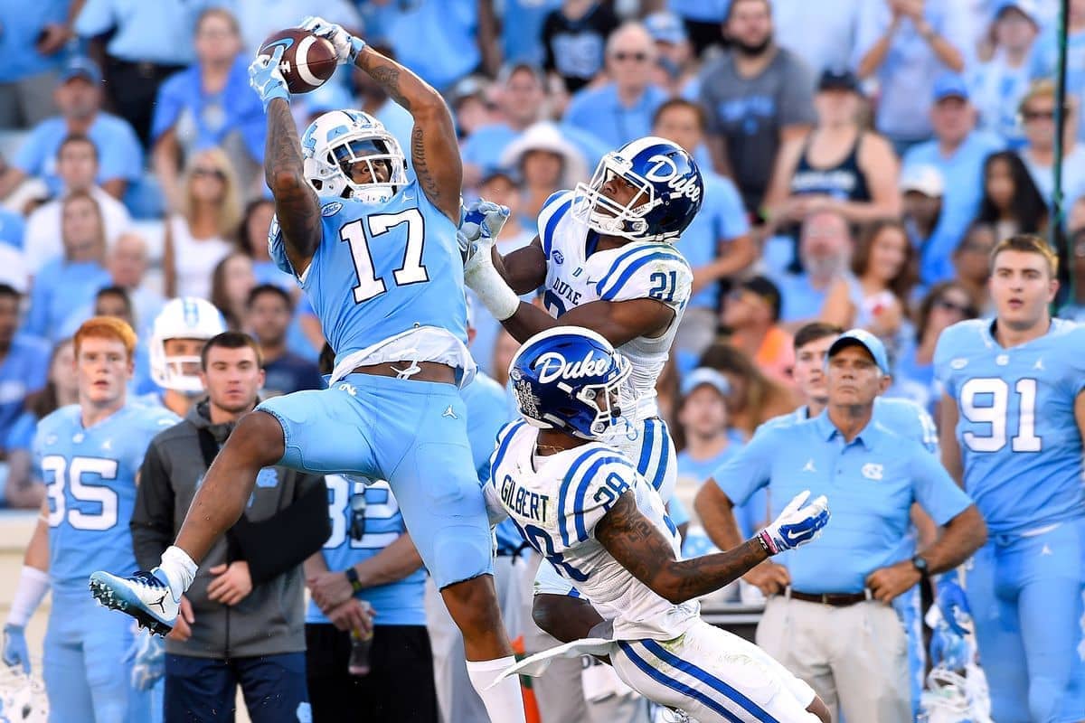 North Carolina Tar Heels wide receivers jumps to catch a pass over Duke defenders