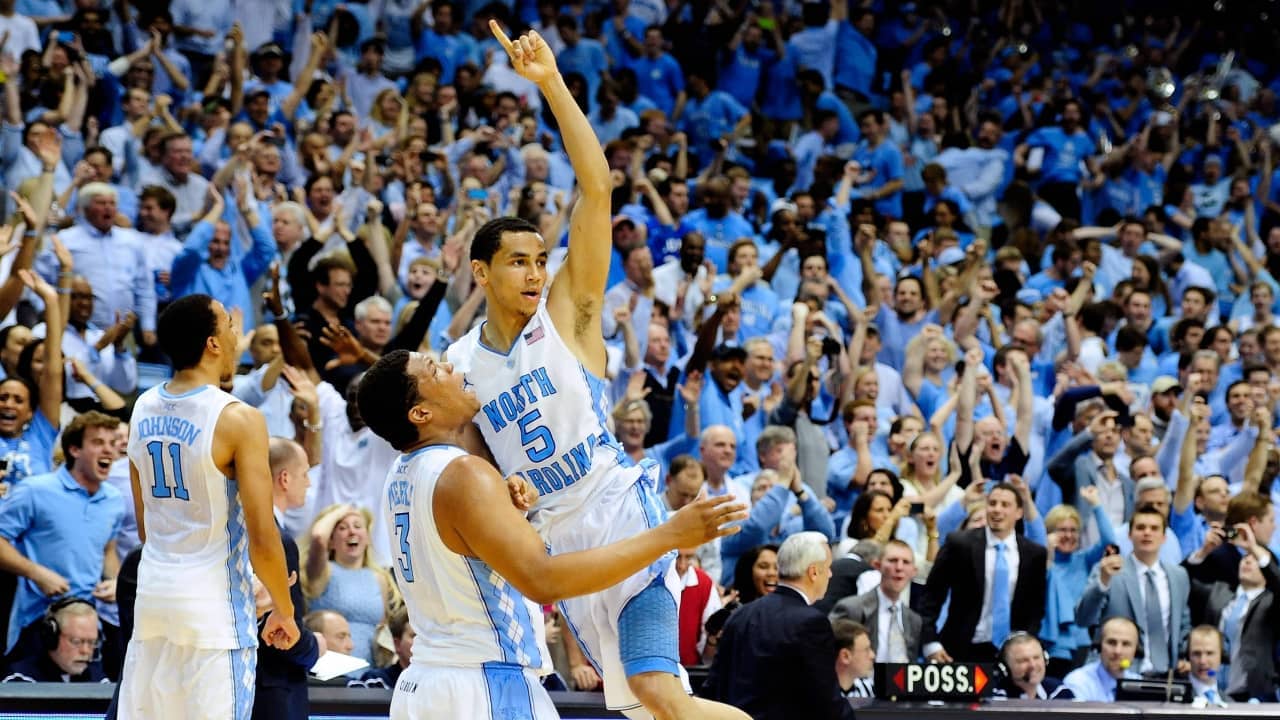 North Carolina Tar Heel basketball player jumps into arms of teammate in celebration